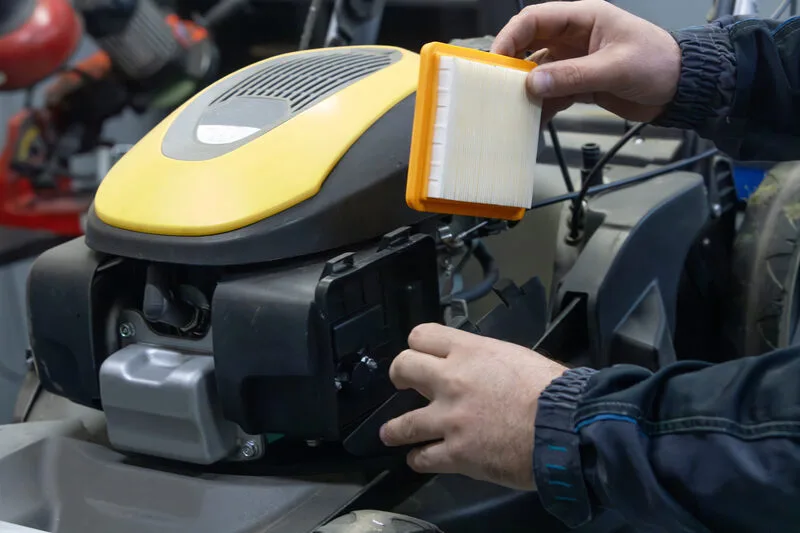 How do you change a lawn mower air filter?