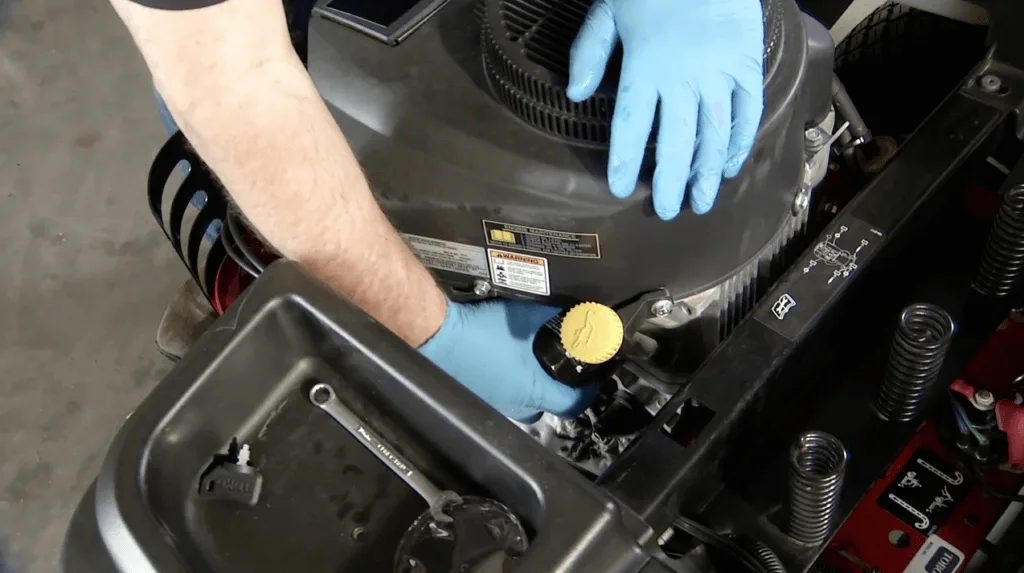 How do you change lawn mower oil?